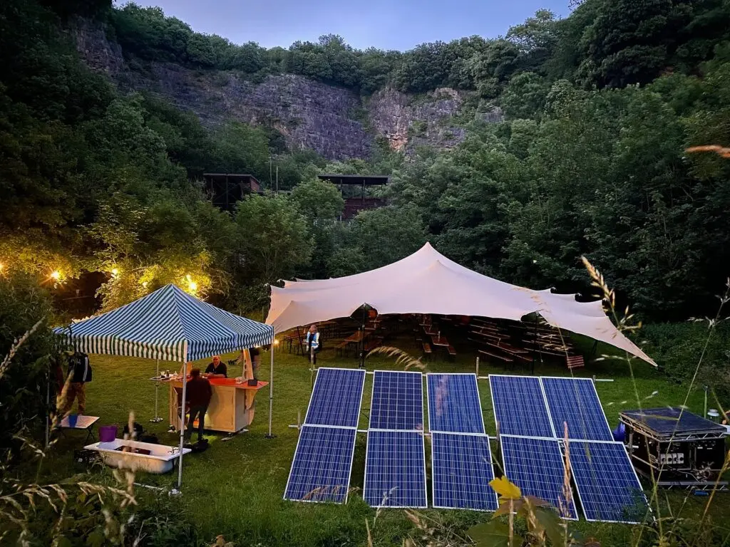 A solar powered event stage in a field.